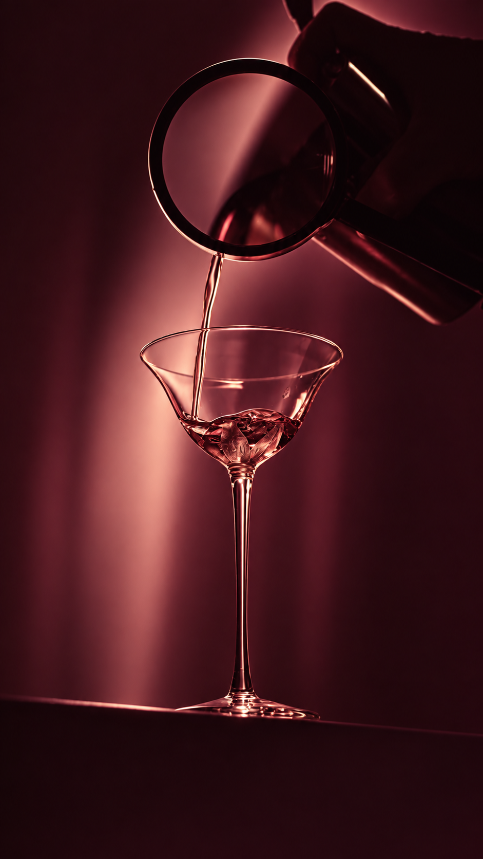 A fresh juice cocktail being poured into a glass